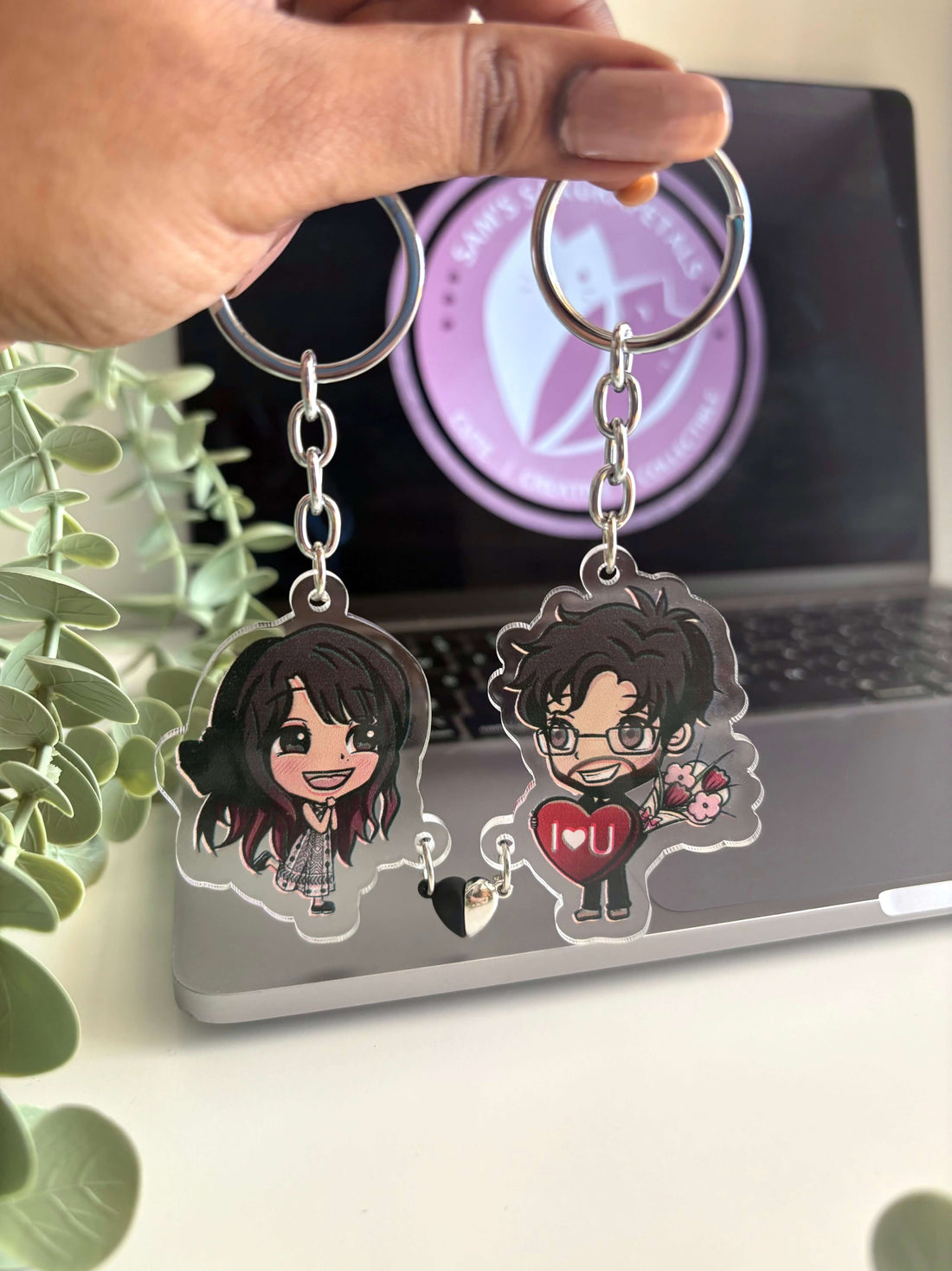 Hand-drawn personalised gift keychain of a couple holding a heart charm