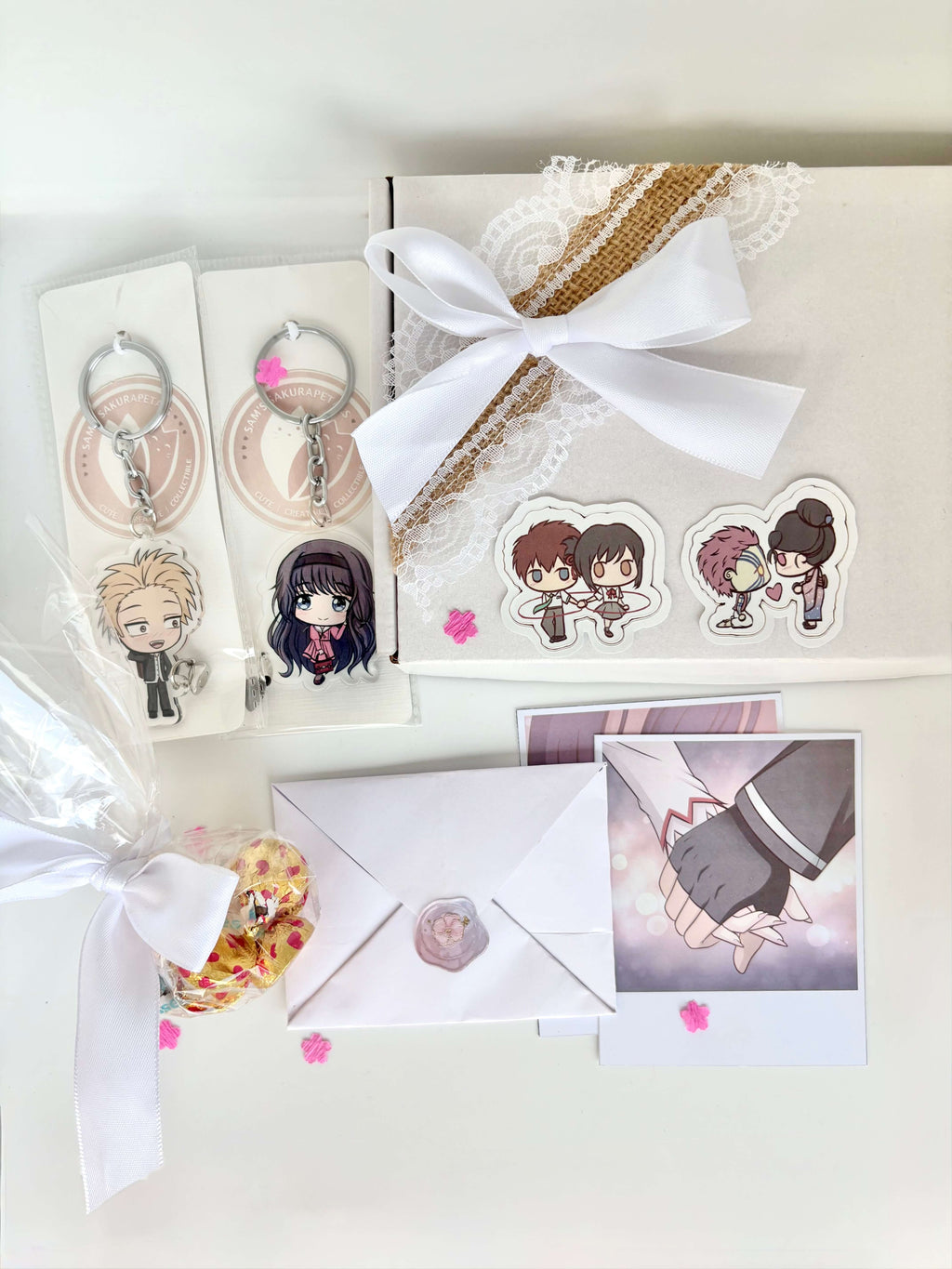 Anime Couple Gift Hamper in soft white packaging with keychain, polaroids, chocolates, letter, and anime couple stickers