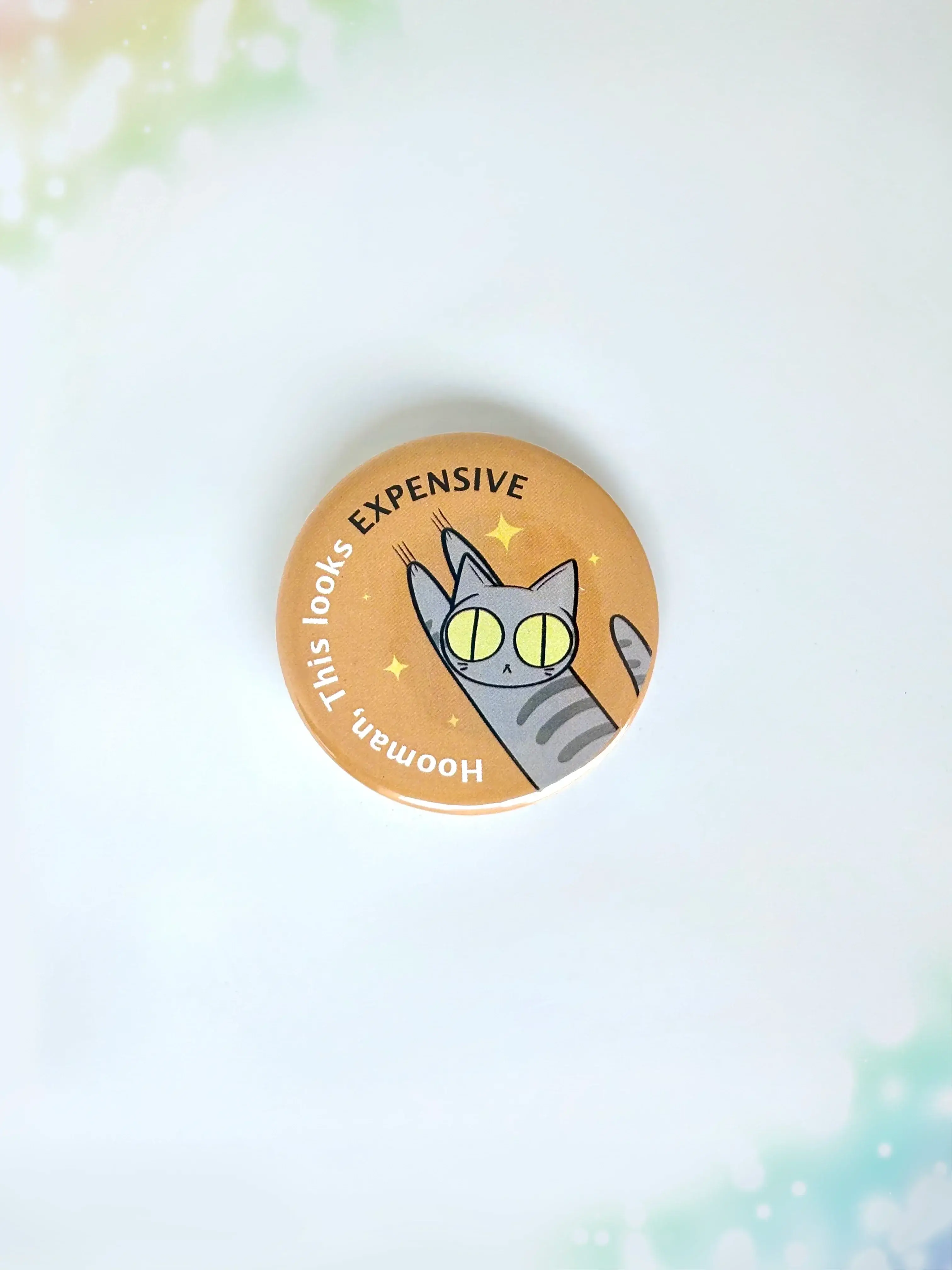 Funny mischievous cat button badge featuring a kitty knocking something over with the text Hooman This Looks Expensive.