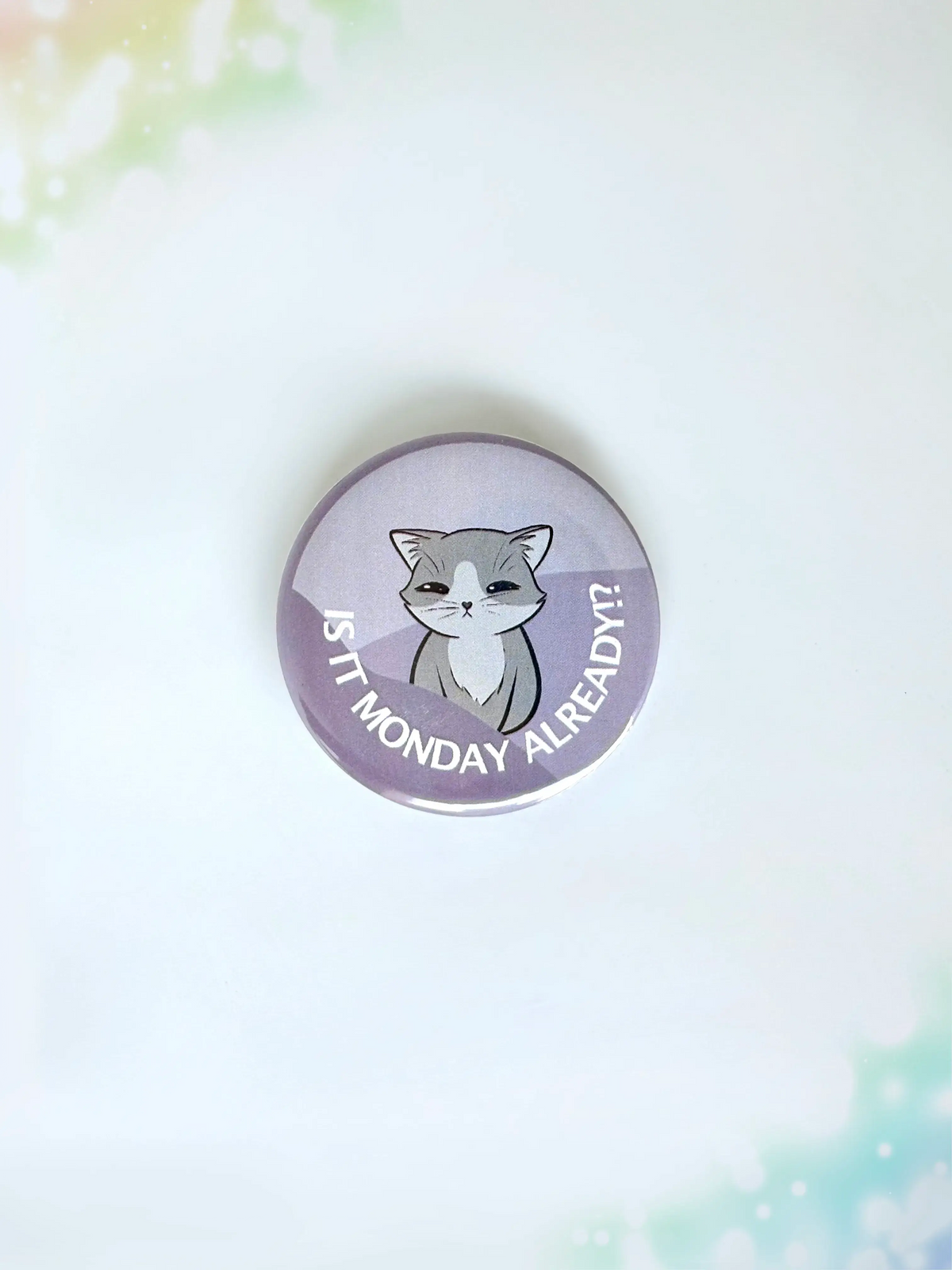 Funny cat merch button badge showing a tired kitty with the text Its Monday Already.