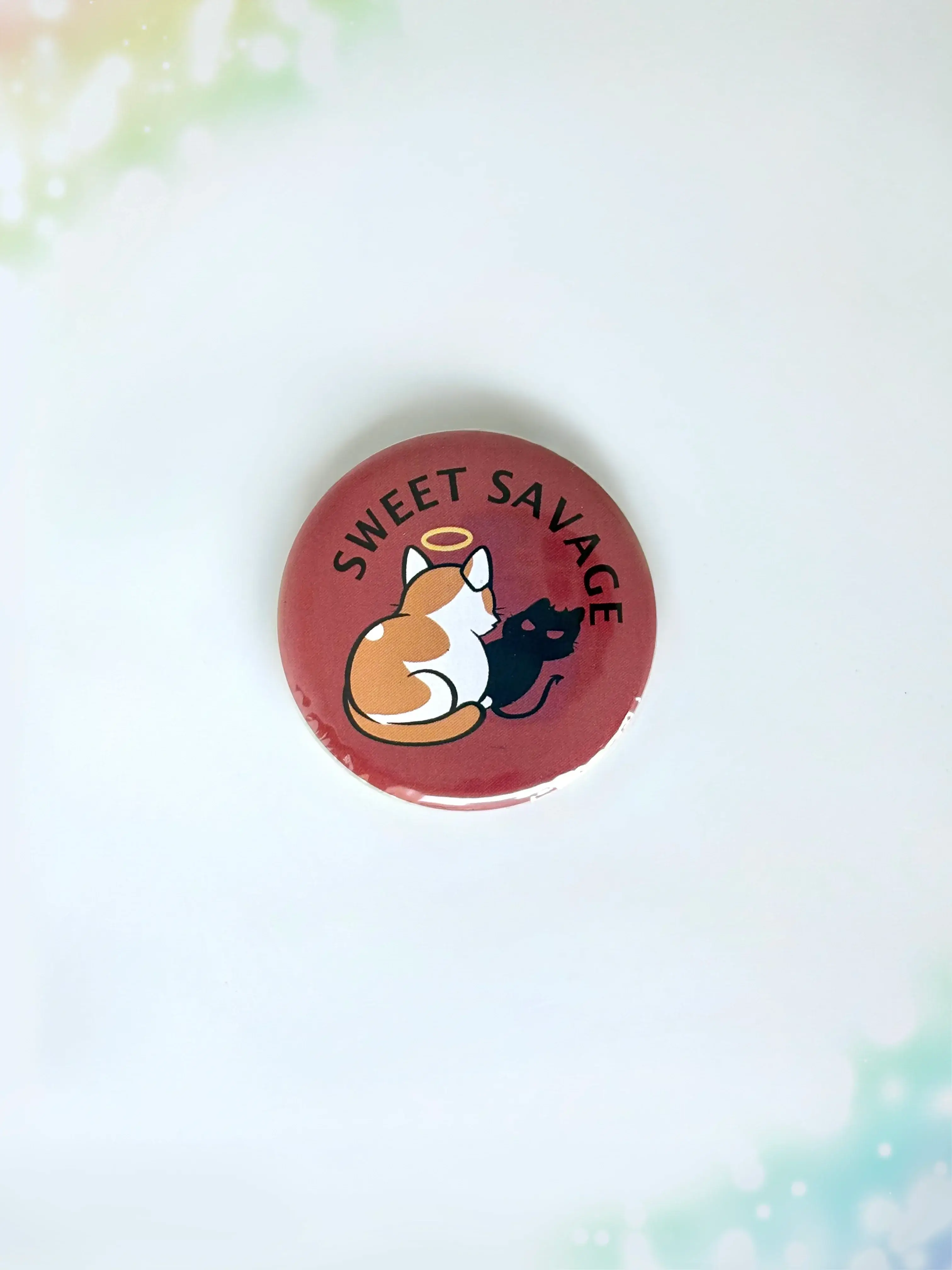 Chibi cat illustration button badge with the text Sweet Savage.