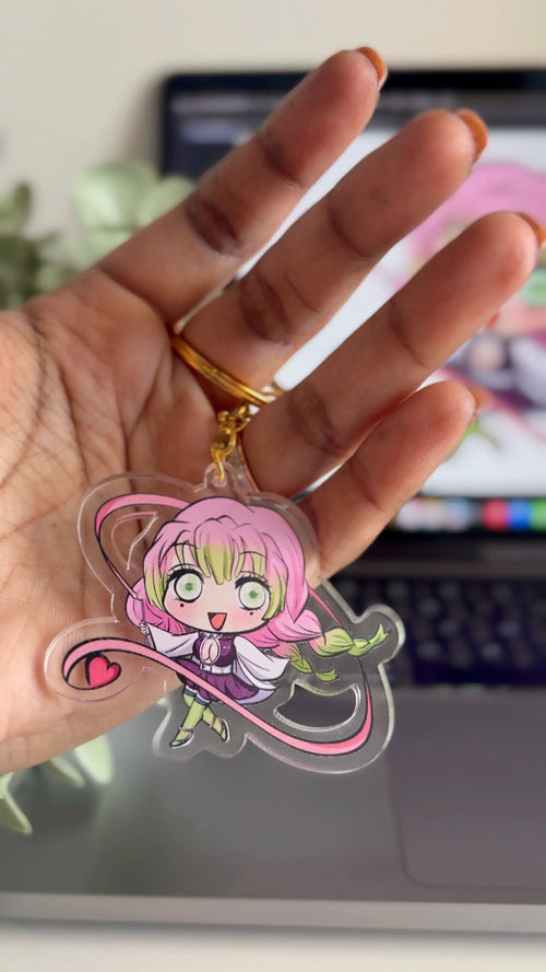 Mitsuri Kanroji fanmade acrylic anime keychain held in hand with a blurred background